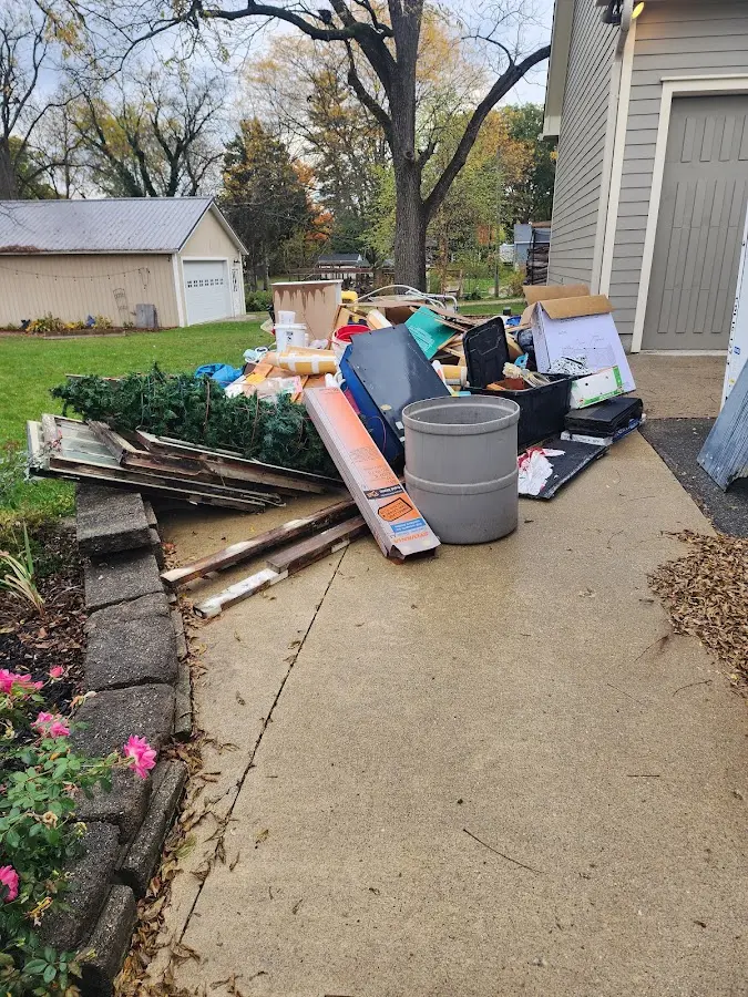 Dumpster being loaded with debris for Commercial Dumpster Rental in Bartlett